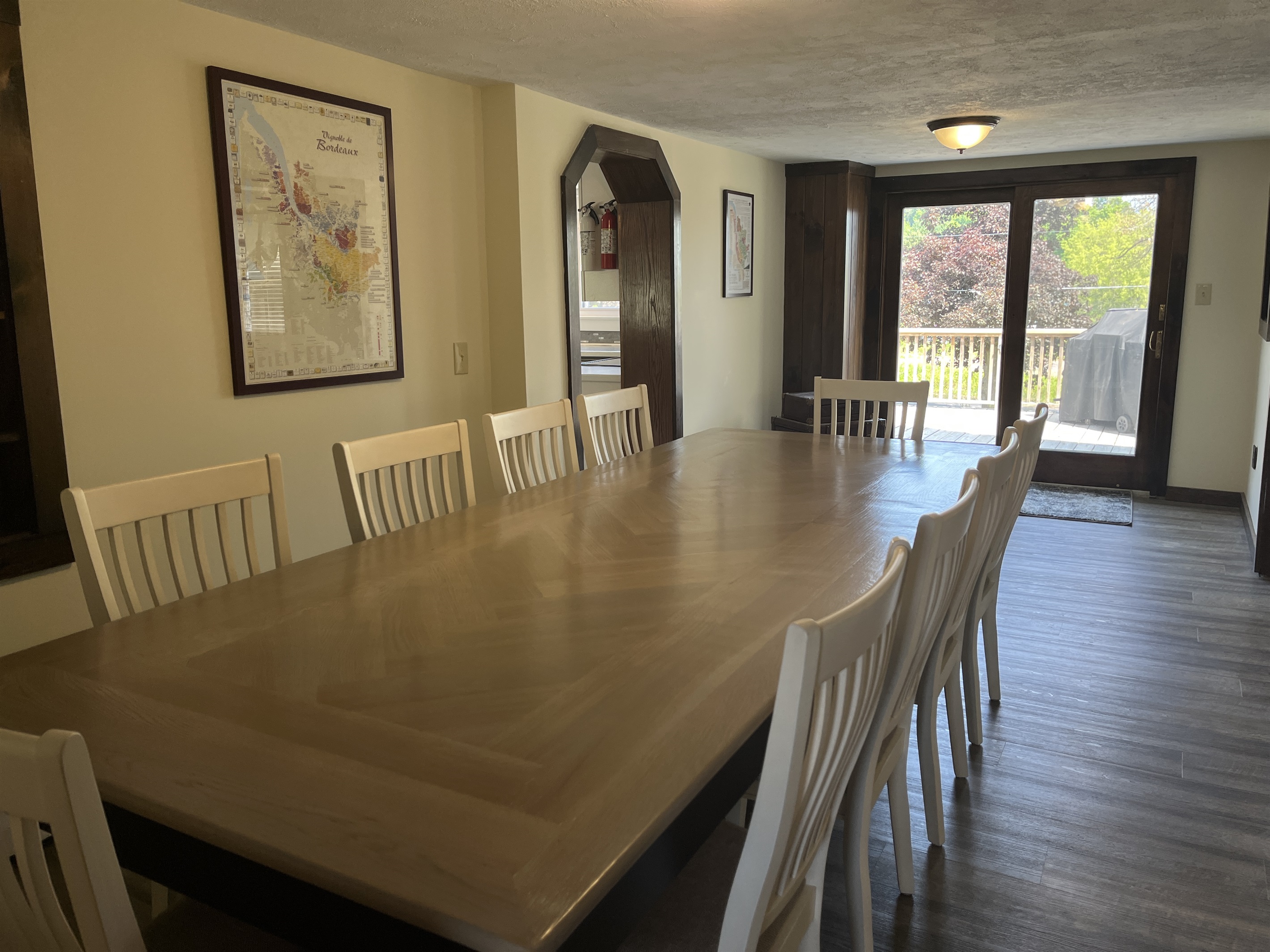 Roundtripper custom built farmhouse table and sliding glass doors leading to the side deck, great for grilling!