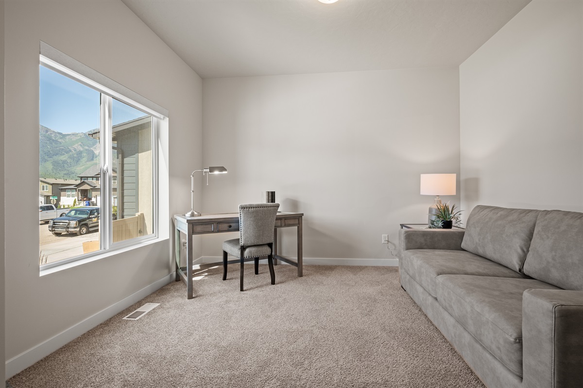 Front entry opens to an office nook with scenic views.