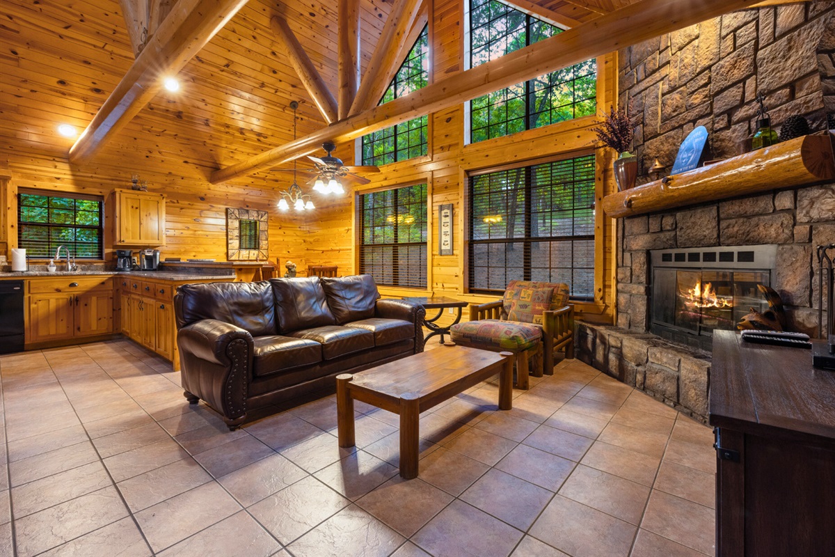 Spacious living area with fireplace and big windows.