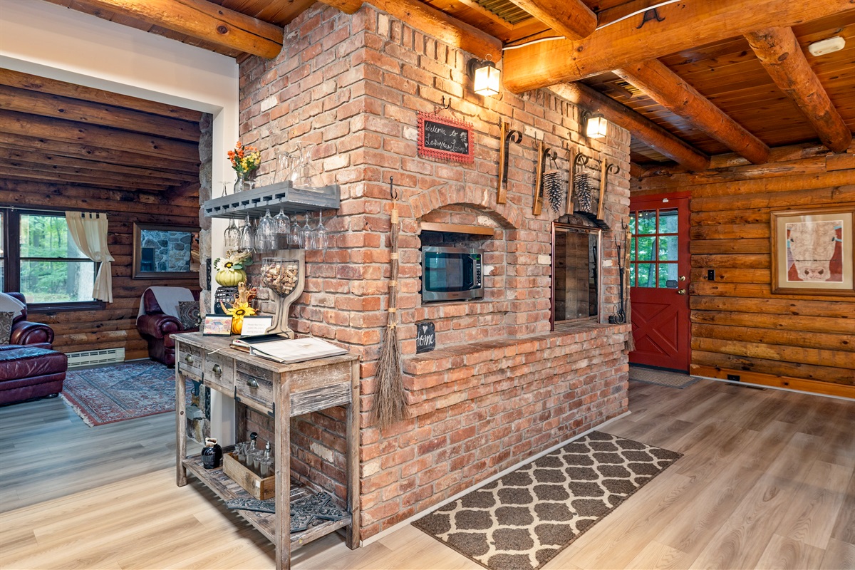 Gather around the stunning brick hearth, complete with rustic décor and a built-in microwave and fireplace.