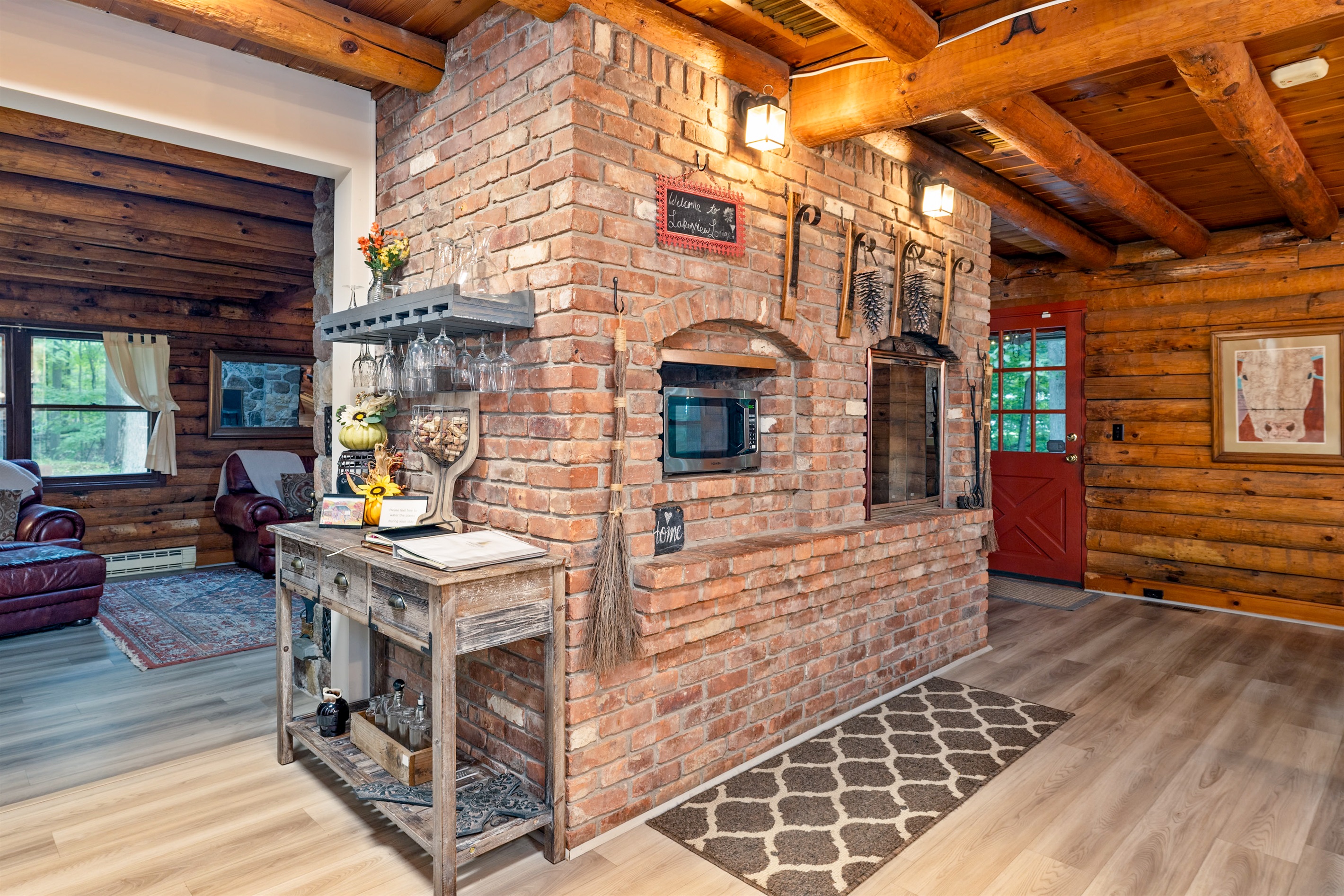 Gather around the stunning brick hearth, complete with rustic décor and a built-in microwave and fireplace.