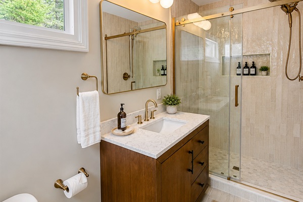 You will want to linger in the new ensuite bath in the primary bedroom. Plenty of space, a 5' shower and lot sof light from the transom windows. Stocked with essentials.
