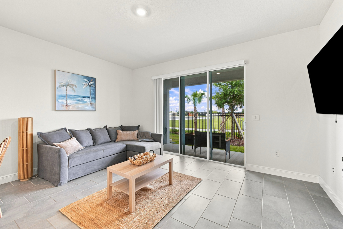 Entertainment area leads to patio and grill through pocket sliding glass door with screen. 
