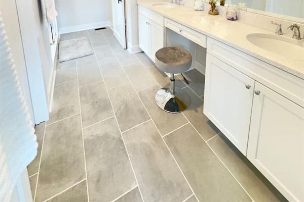 The master bath has a spa vibe with light flooding in from windows in the large glass shower. Guests will love the double quartz vanity with the seated make-up area and huge walk-in closet with barn doors. SO many curated details in the master suite!
