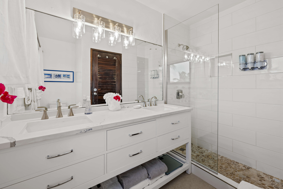 Private primary bathroom featuring a clean and comfortable space to refresh.
