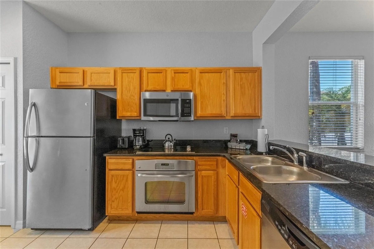 Large kitchen with stainless appliances and solid surface countertops