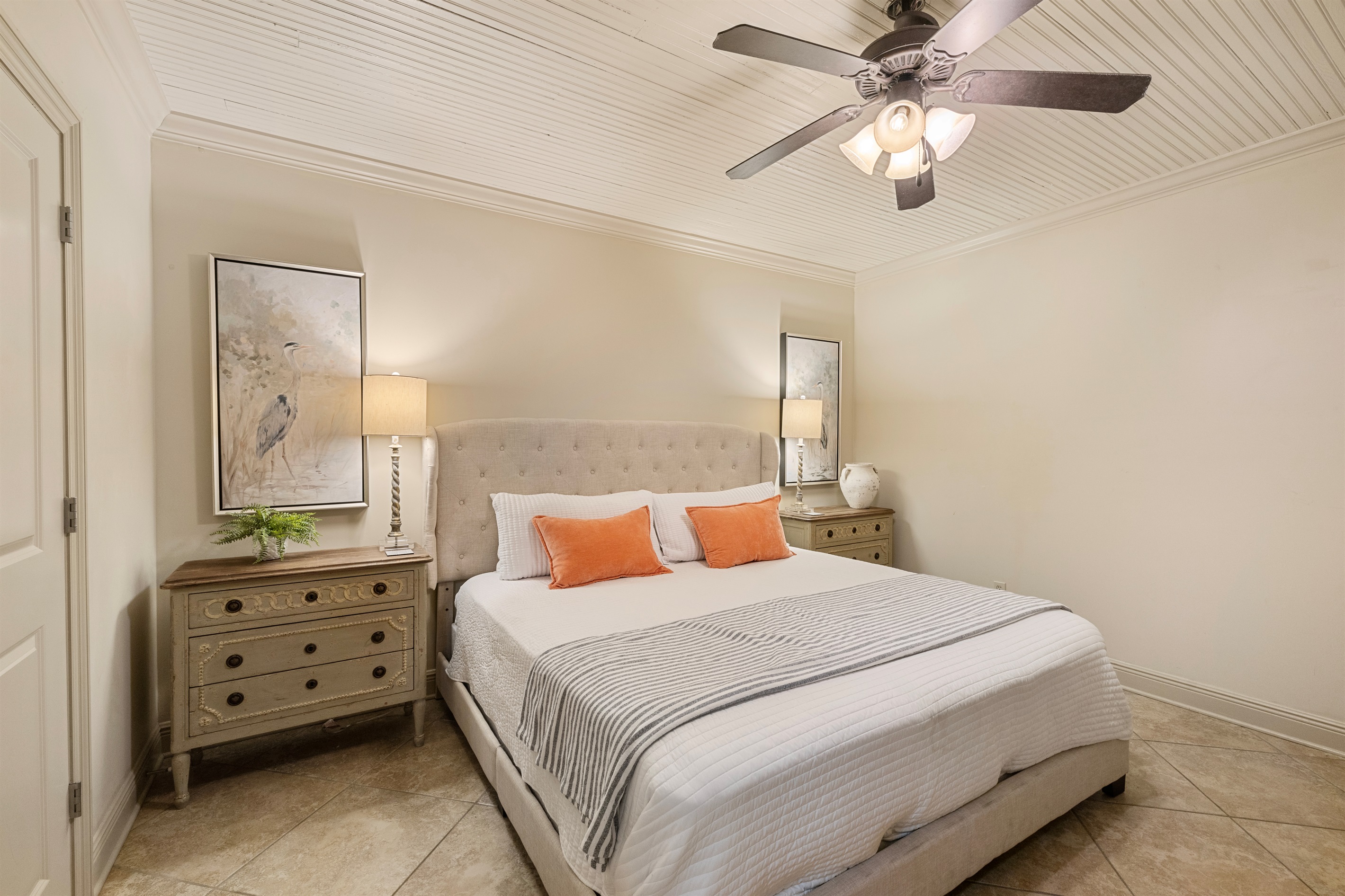 Elegant king bed adorned with vibrant accents and ambient lighting awaits