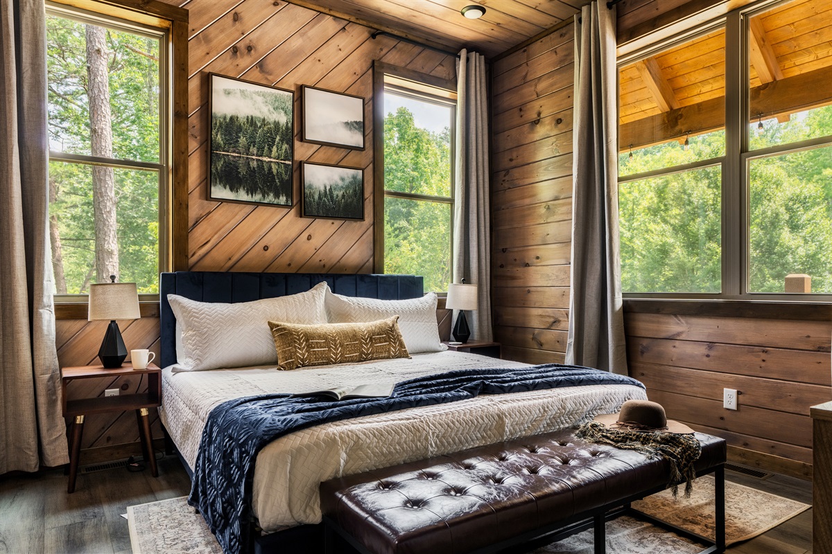 Spacious king bedroom with warm wood finishes and cozy charm.