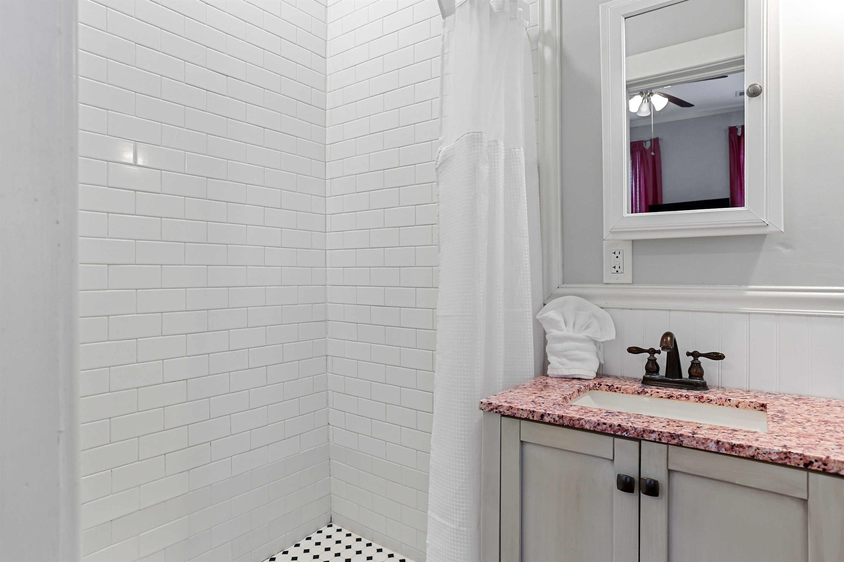 Enjoy the walk-in shower with a simple curtain for easy access.