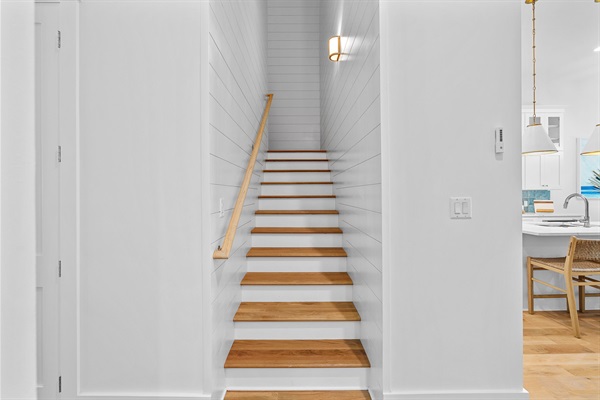 Well lit staircase with shiplap