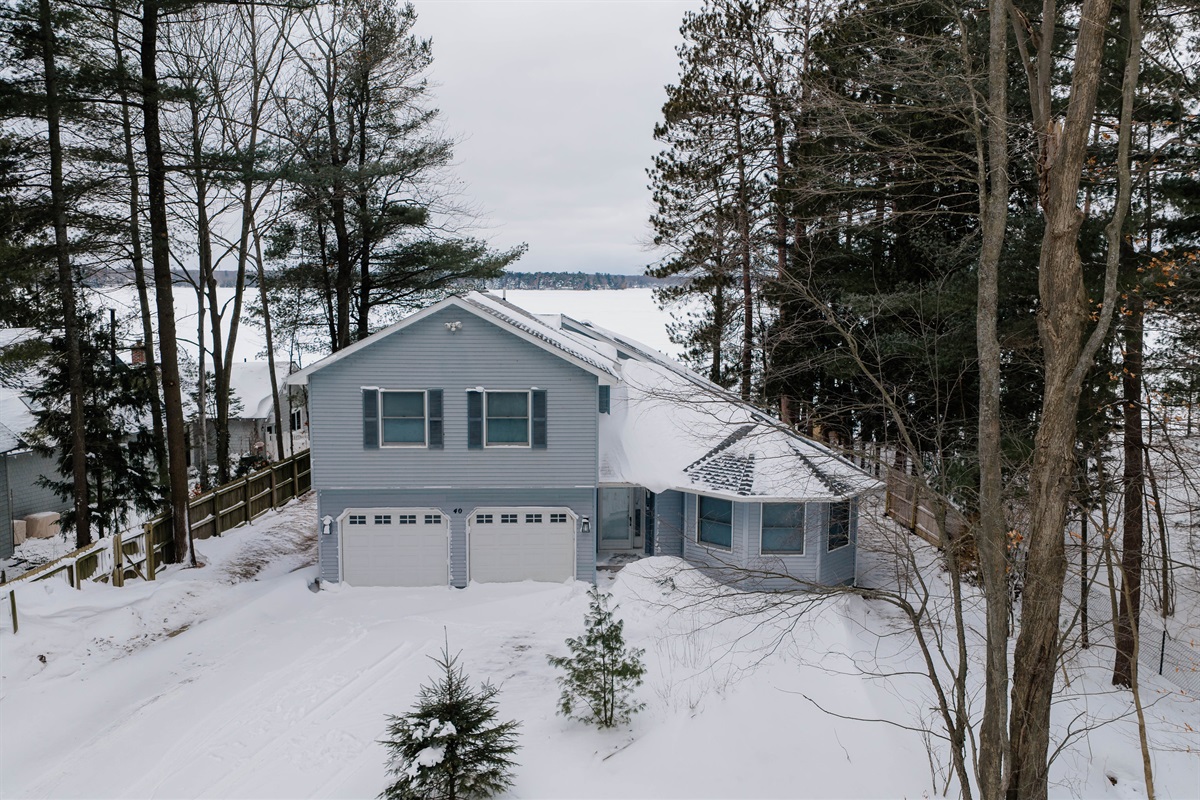 Lakefront exterior with private driveway and winter views of Long Lake