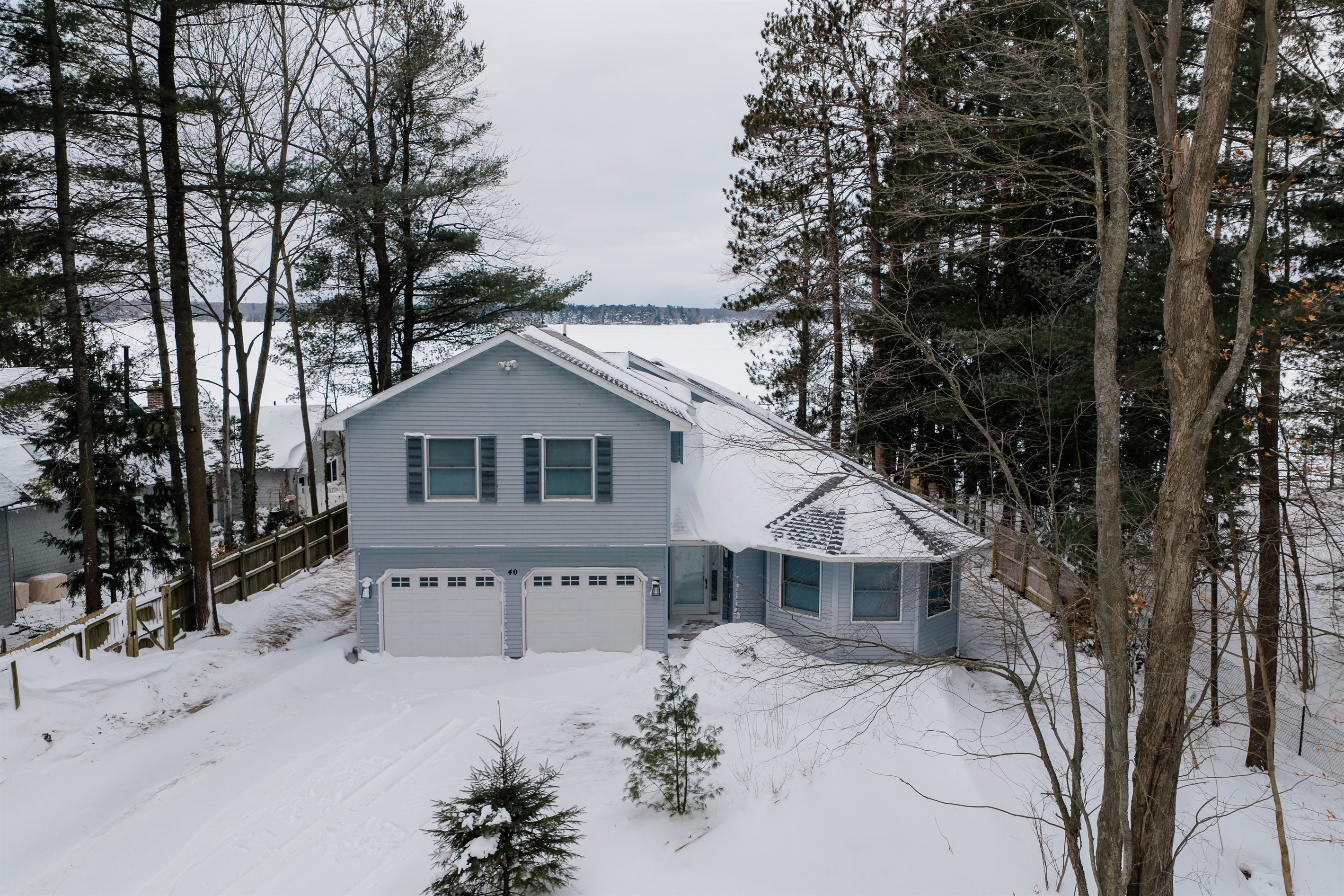Lakefront exterior with private driveway and winter views of Long Lake