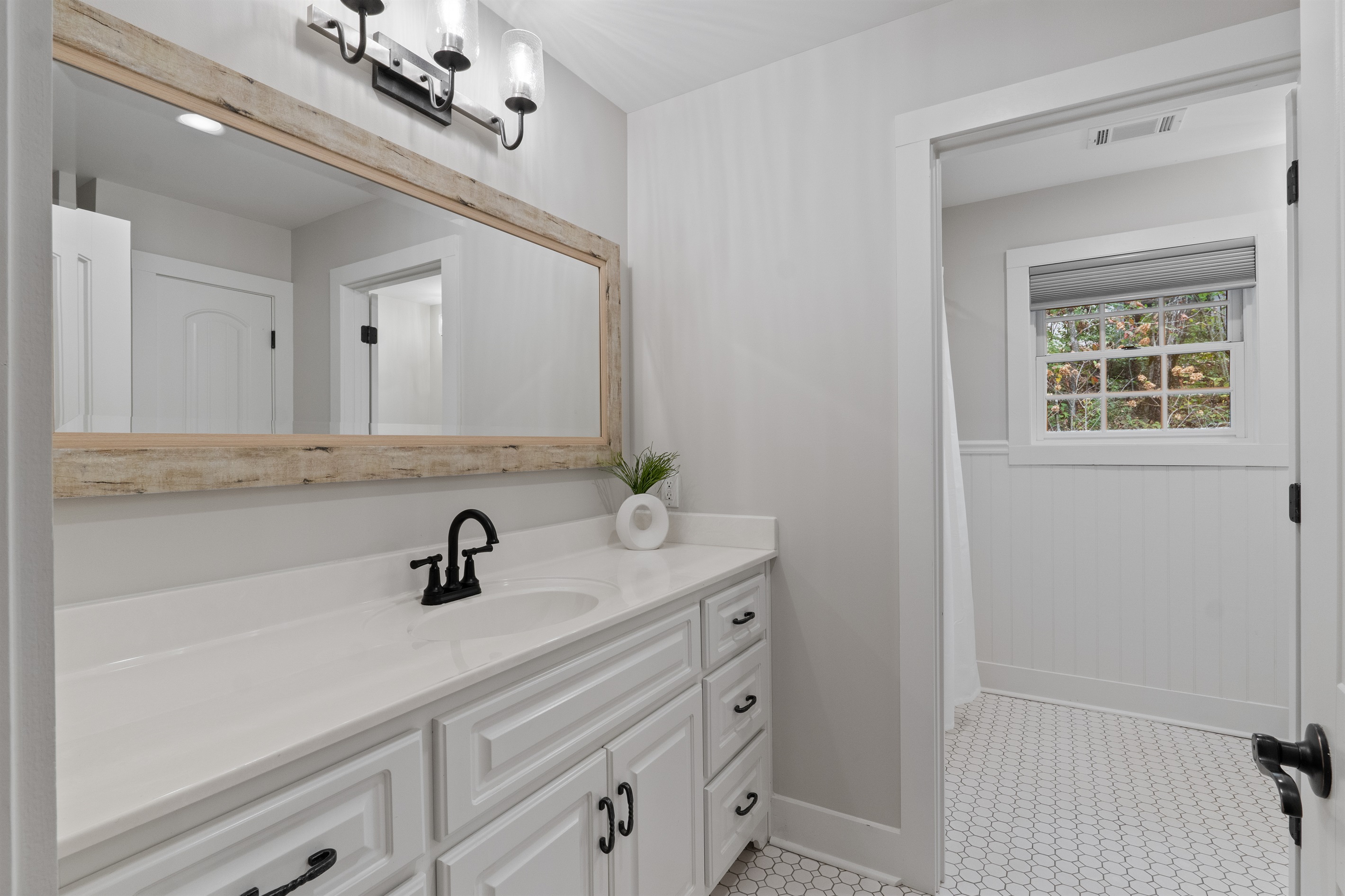 The upstairs full bath includes a shower-tub combination, offering convenience and comfort for guests.