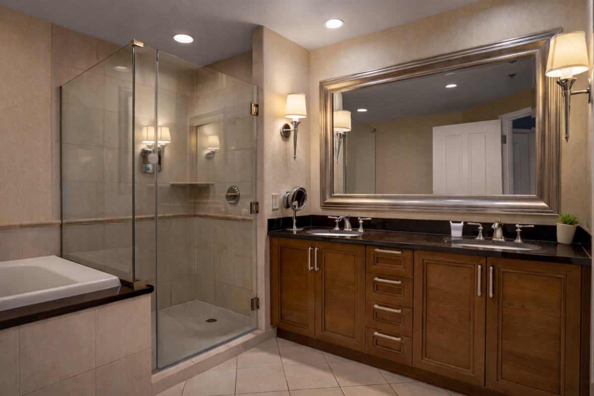 Unwind in a spacious ensuite with a glass shower and deep soaking tub.