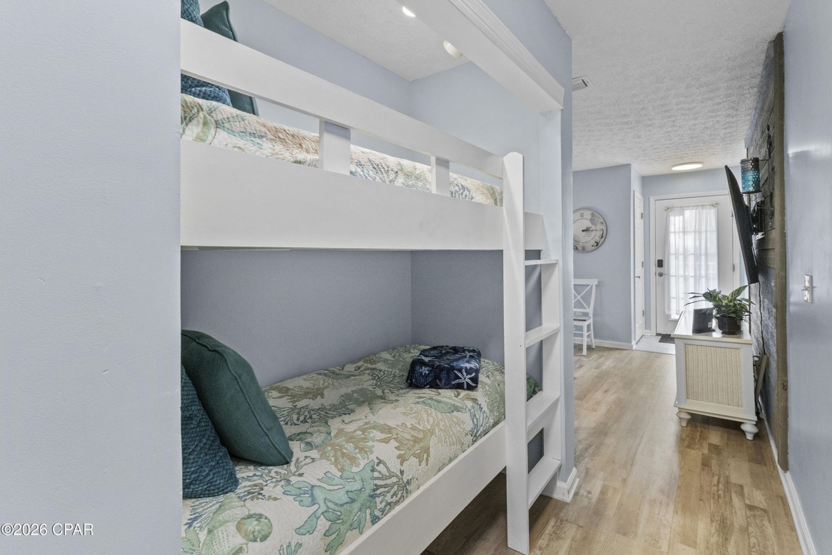 Hallway twin bunk beds — perfect for kids or extra guests, with easy bathroom access.