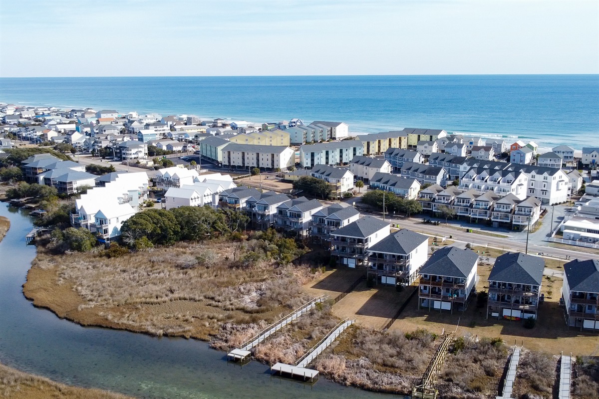 Aerial view of the home and surrounding neighborhood: perfectly positioned between calm waters and the beach.