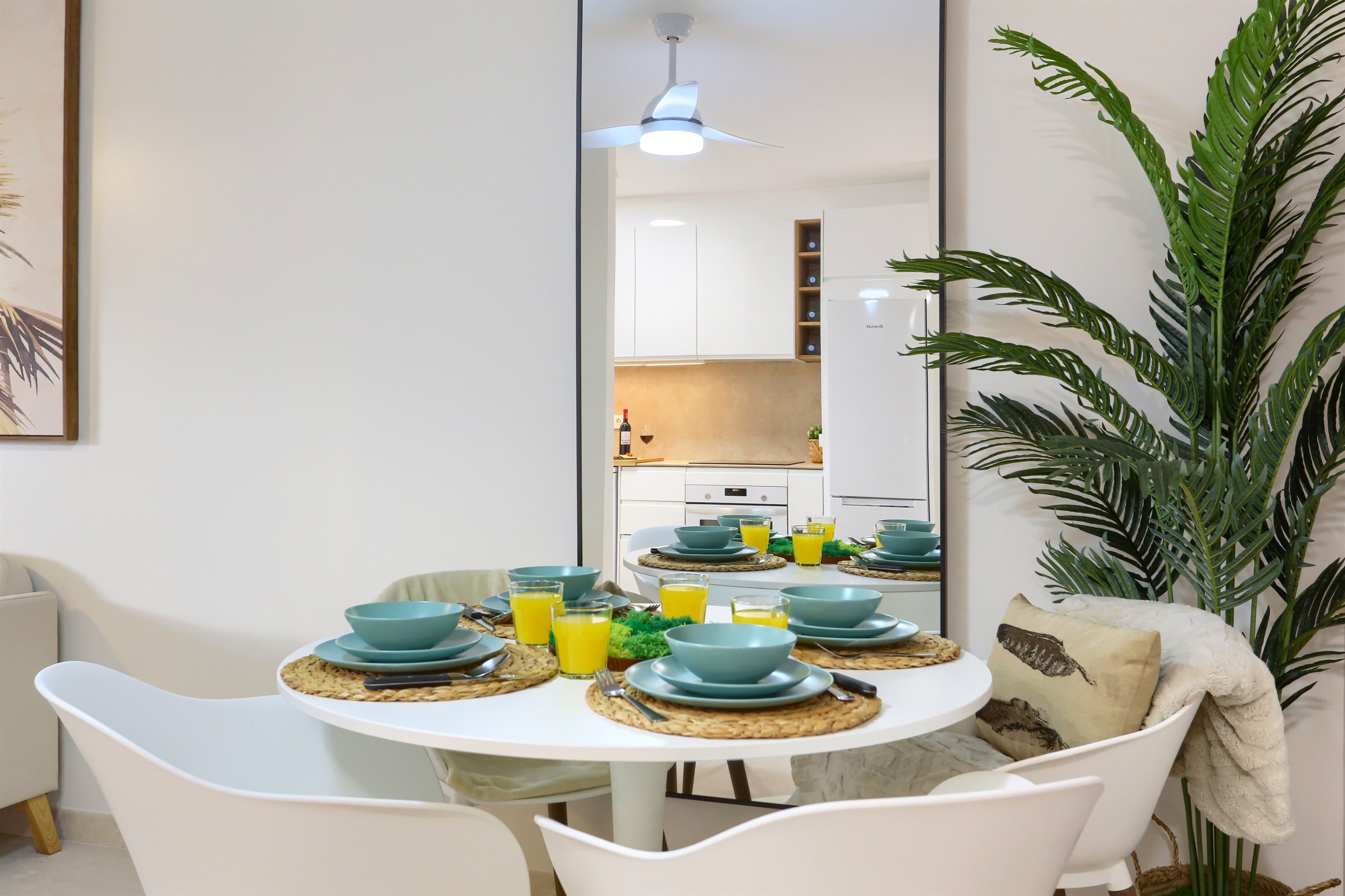 Elegant dining area with a table perfect for enjoying meals together, set within a modern and bright open space.