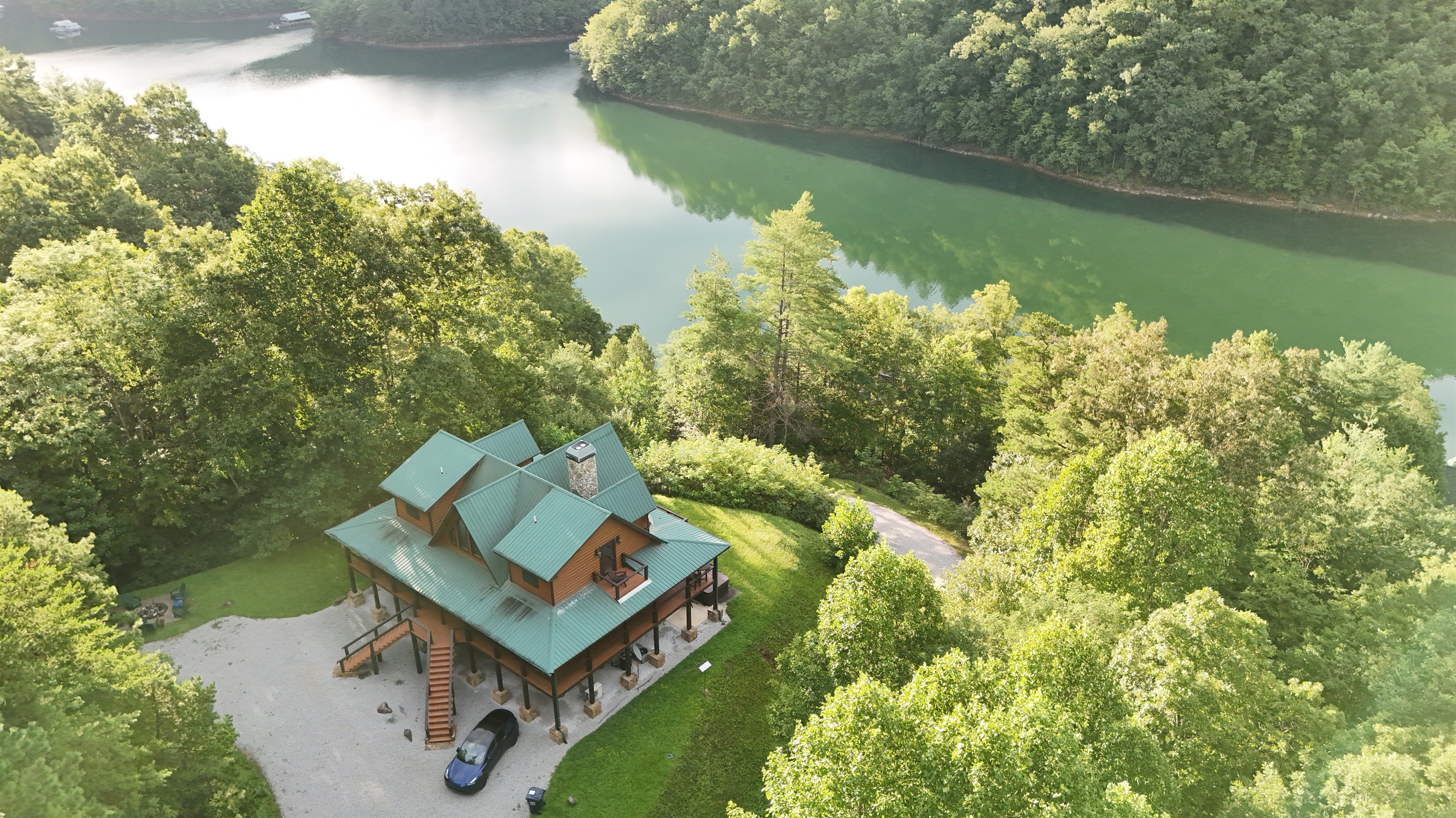 Nature's embrace. This stunning home is perfectly situated amidst the lush greenery of the mountains.