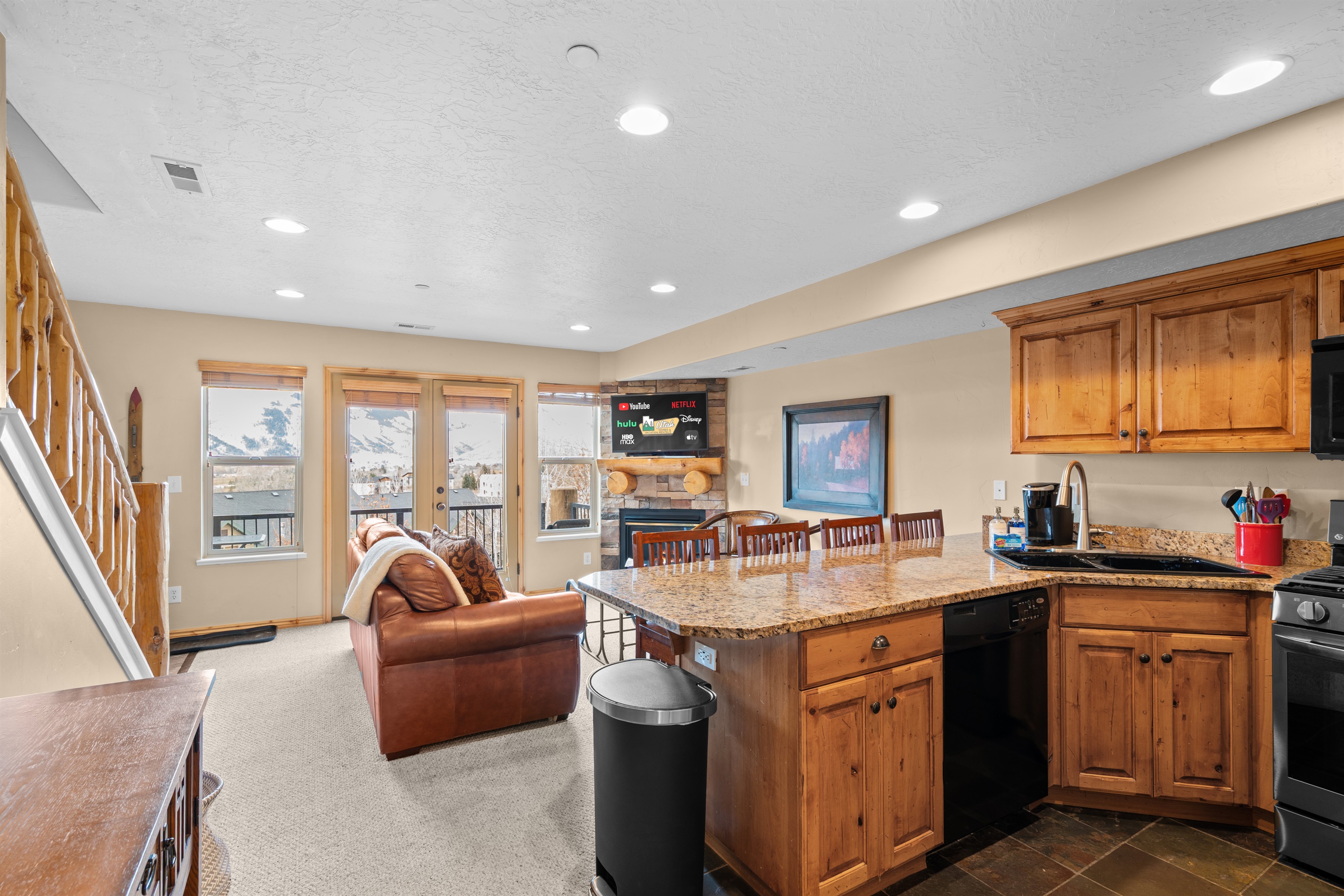 Open-concept kitchen and living area with warm wood finishes — perfect for gathering after a day of mountain adventures.
