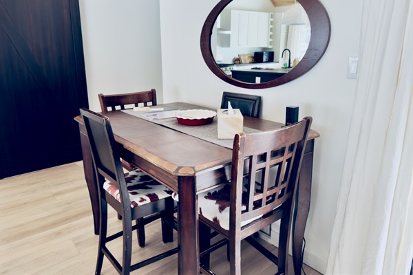 Dining table beside the kitchen for shared meals or games
