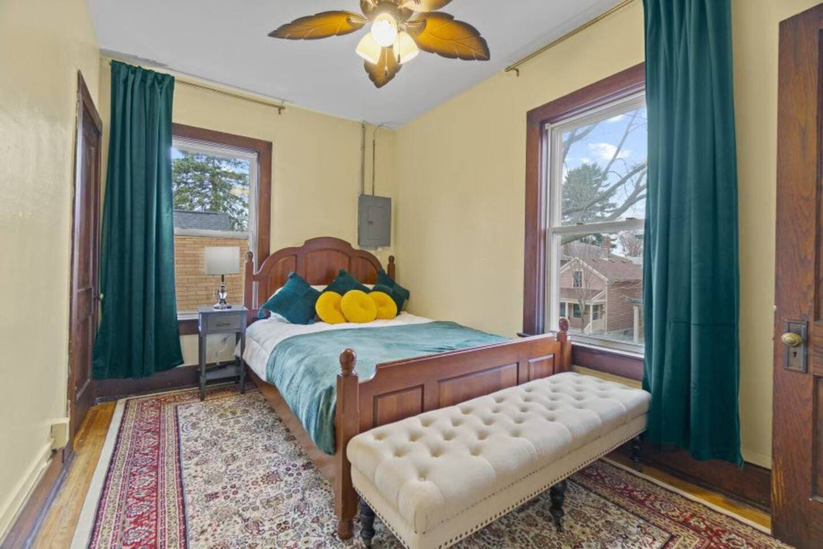 Spacious bedroom with ample windows, allowing natural light to fill the room and create a bright, airy atmosphere.