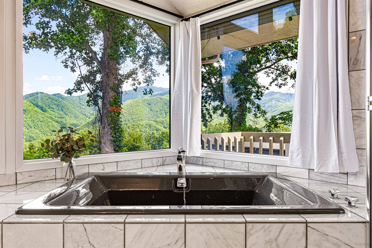 Indulge in mountain views from this luxurious soaking tub!