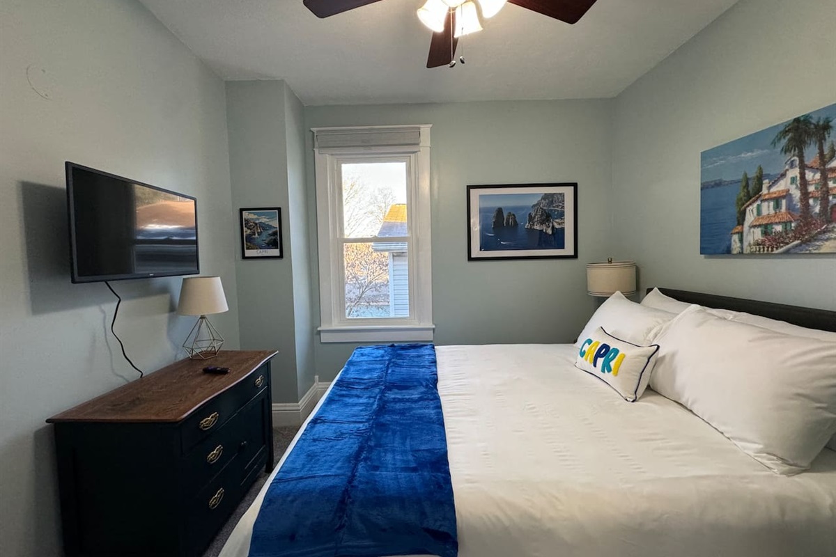 The Capri Room on the Upper Level includes a Queen bed and Roku Smart TV.