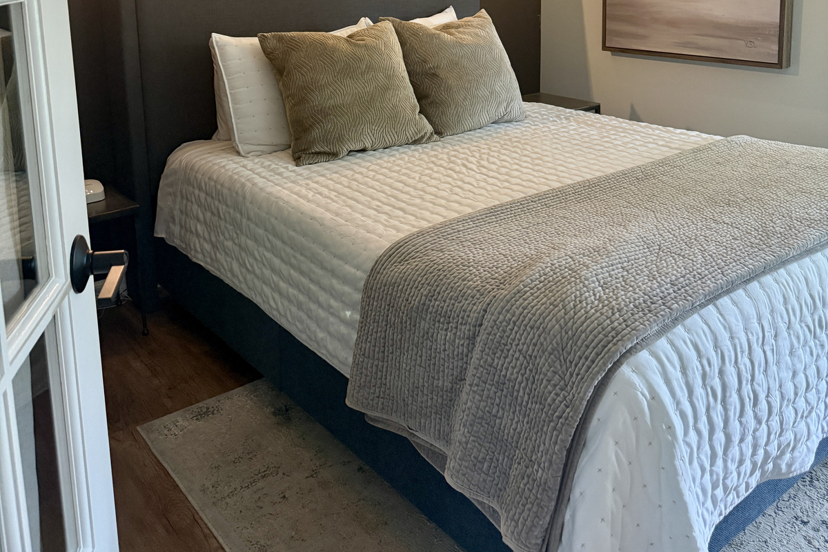 Settle in to the 1st floor bedroom, located just off the main living area and a short distance to the half bath on the main floor. Glass doors with shade close for privacy.