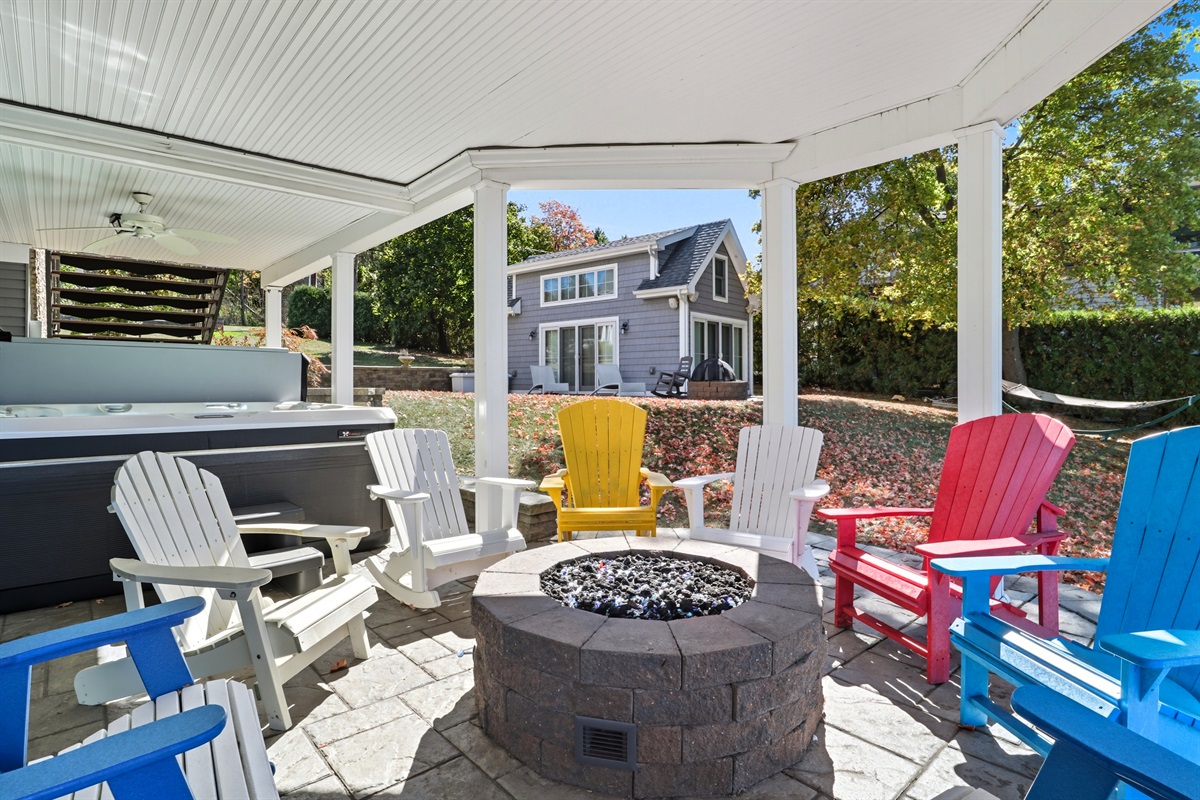 Comfortable outdoor lounge with fire pit and hot tub for evening gatherings.
