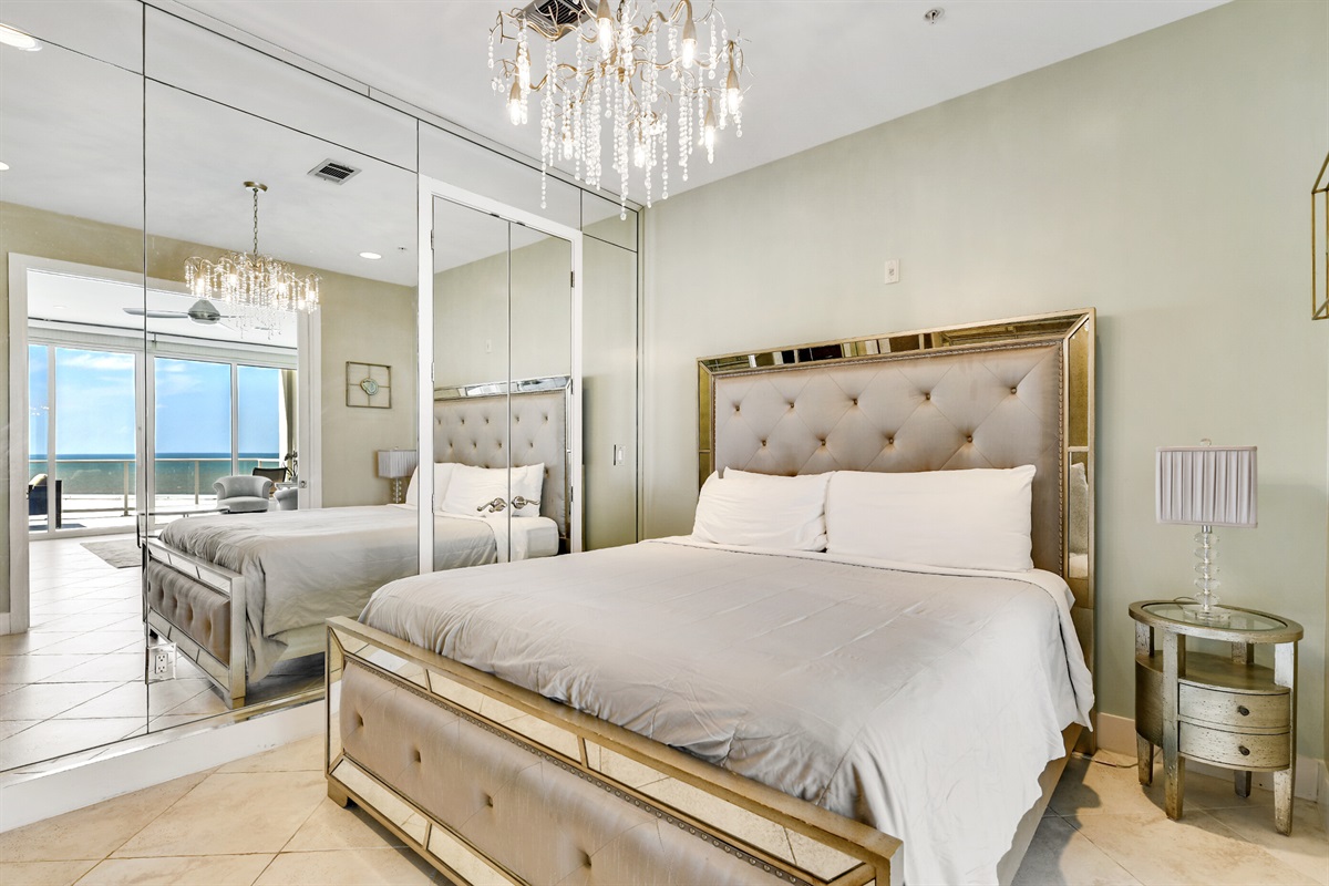 Master bedroom with KING bed and beautiful mirror wall.  Gorgeous chandelier.