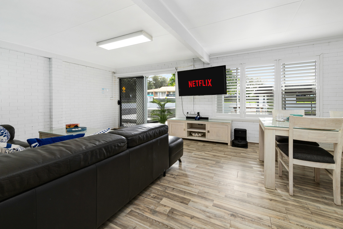 The downstairs living room gives Skye’s Beach House a second lounge zone, helping the two-level beach-house layout feel more flexible.