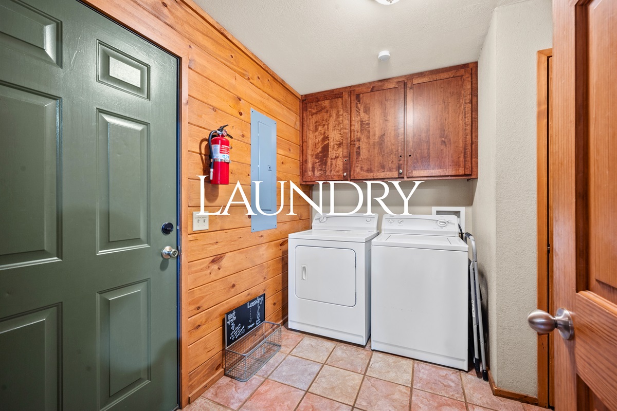 Washer and dryer available for guest use, with cabinet storage and direct exterior access.