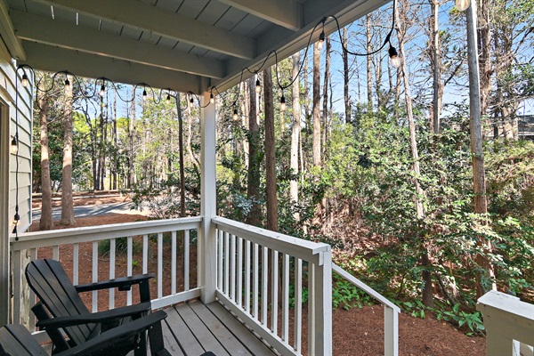 Secluded and serene back deck off of the living room with seating. 