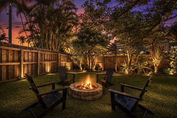 Private fenced outdoor space with fire pit