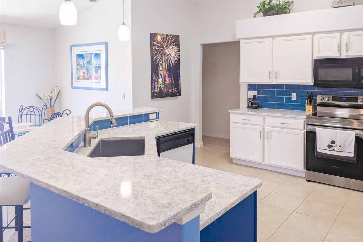 Fully stocked Kitchen with stainless steel appliances, granite countertops, breakfast bar, and breakfast nook.