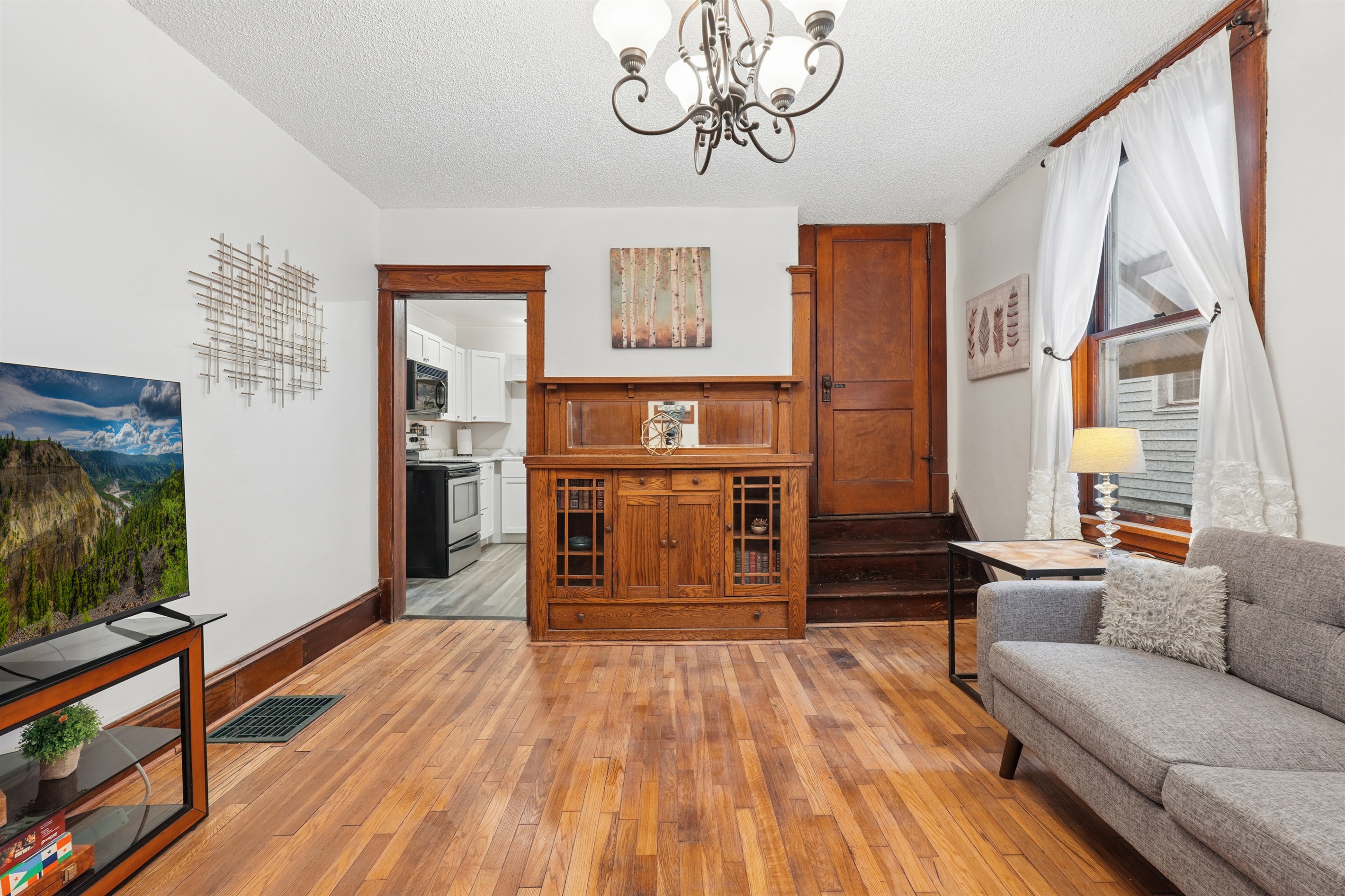 The spacious living room connects to the kitchen and to the other bedroom.