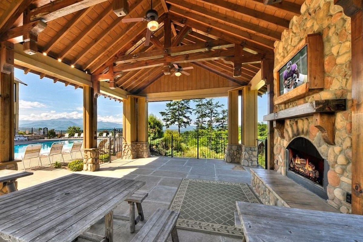 - Outdoor pavilion with stone fireplace and cozy mountain-style seating   - Perfect for family gatherings with scenic views and open-air comfort   - Watch TV or relax by the fire while surrounded by Smoky Mountain charm