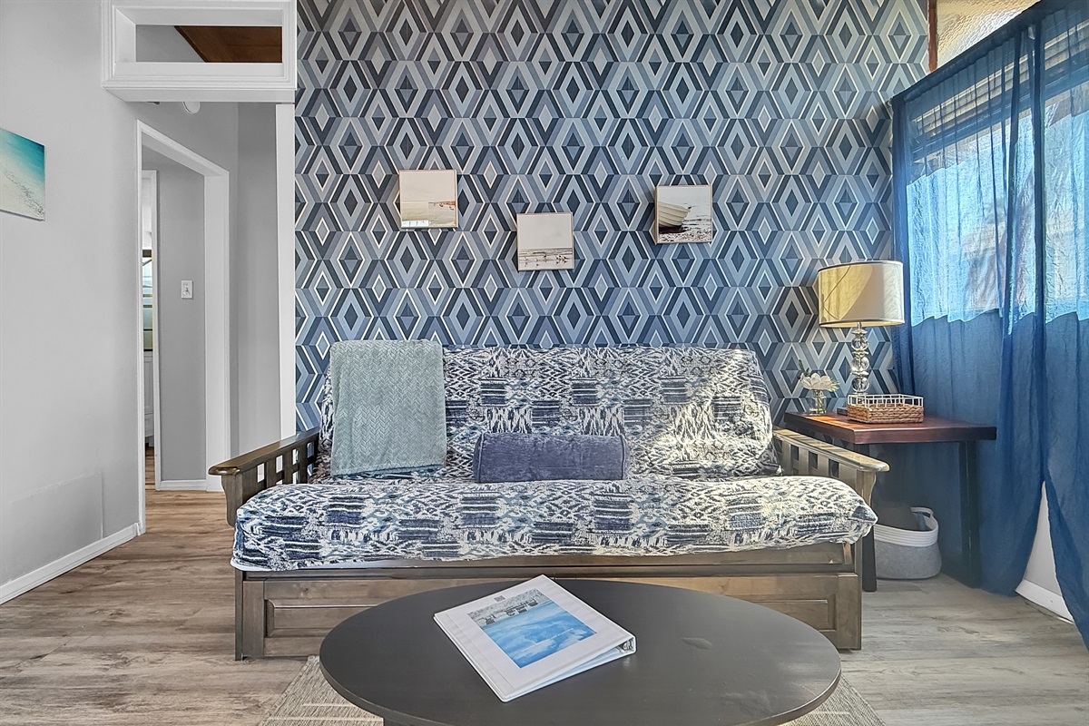 Relax in the cozy living room, complete with a full futon and smart TV, perfect for winding down after a day in the sun