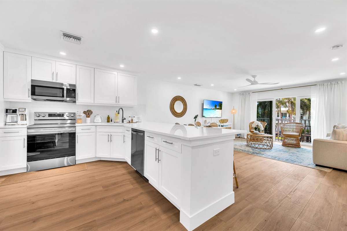 A beautifully designed spacious and modern kitchen with white shaker cabinets, marbled quartz countertops, stainless steel appliances, ice maker and fully equipped with everything you need to serve 6 - 8 guests.