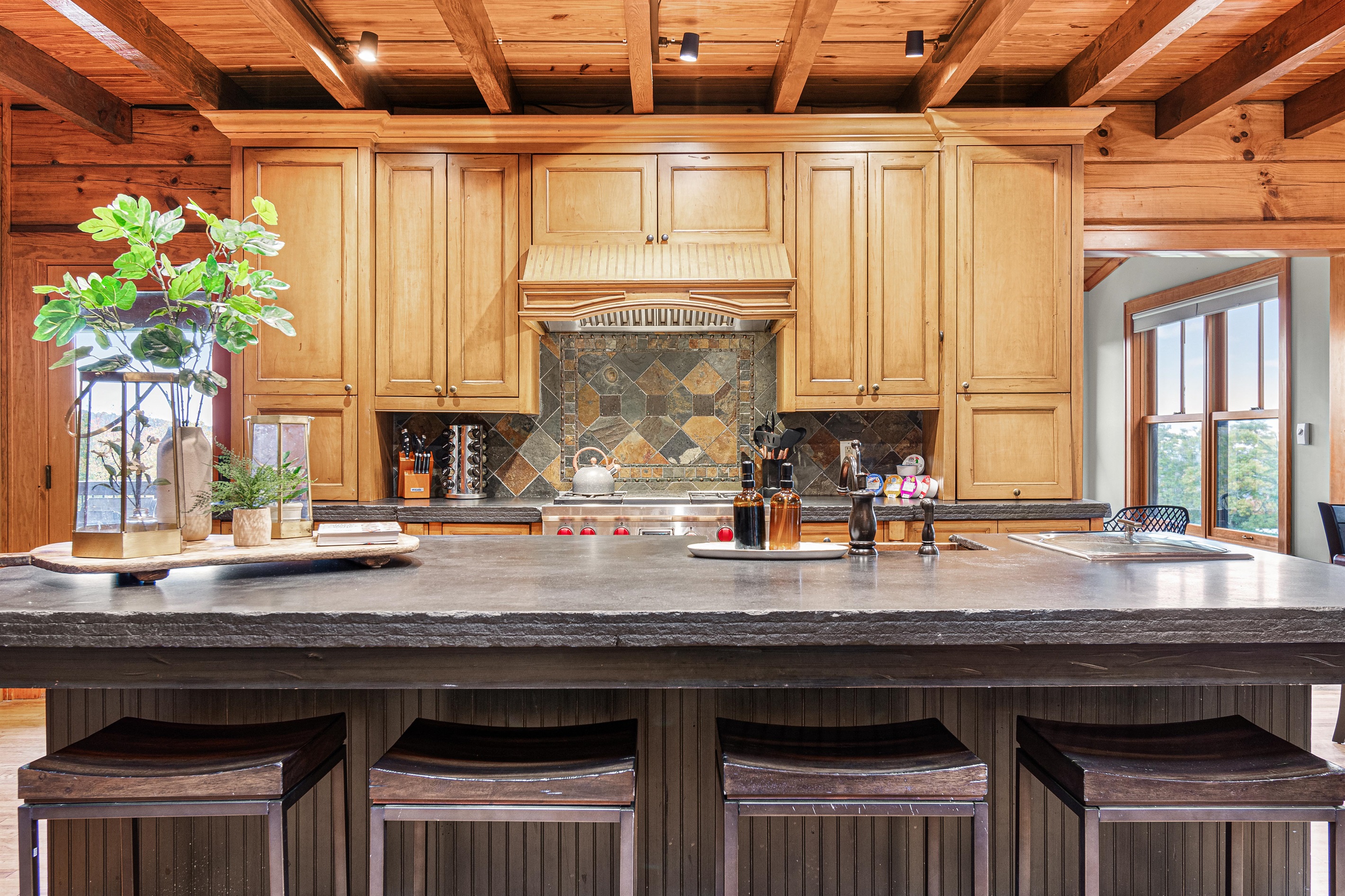 Very large kitchen island that seats 5 guests with ample counter space.