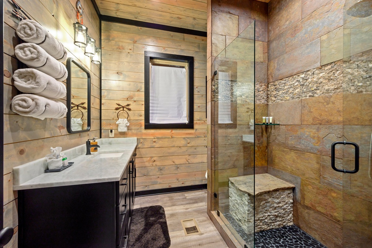 Beautiful shower with built in seating.  Located downstairs outside of bedroom 2.