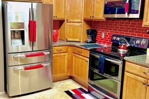 A modern and fully equipped kitchen featuring stainless steel appliances, ideal for preparing delicious meals.