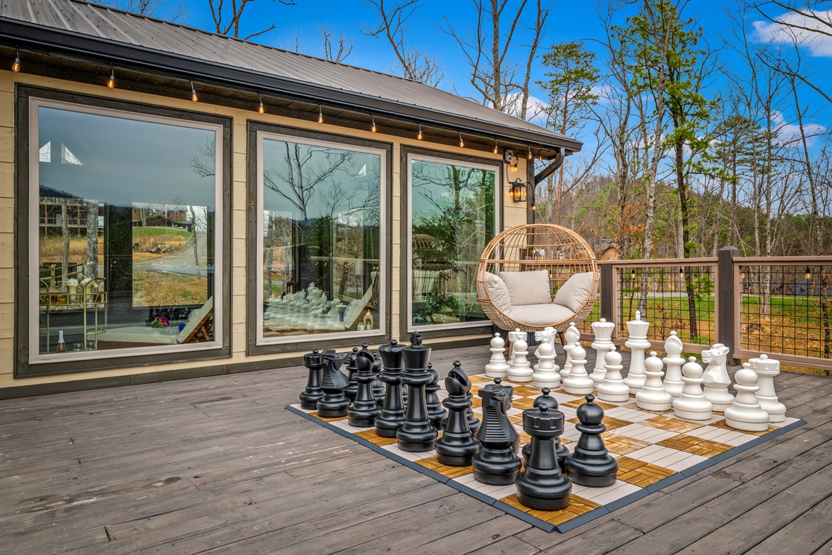 Play a game of giant chess or relax in the cozy egg chair on the deck, conveniently accessed from the living room and pool room.
