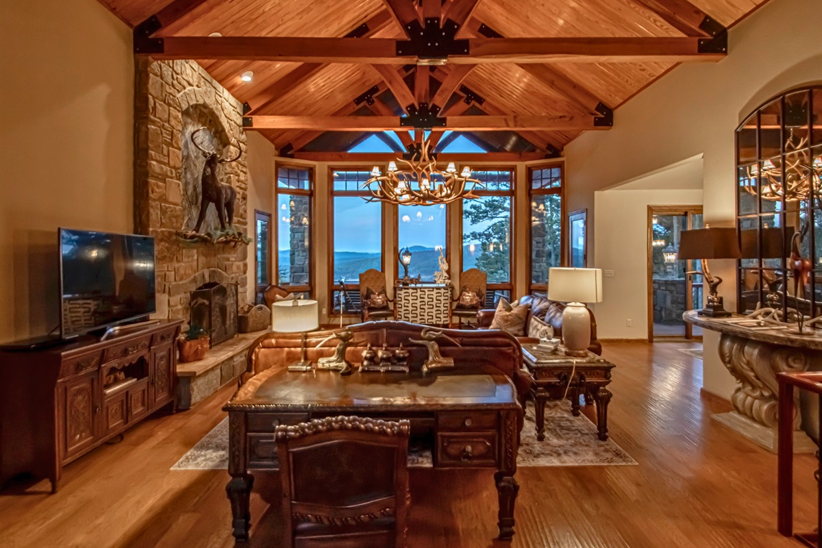 Gorgeous and Rustic Living Room with Exposed Wood Ceiling and Brick Fireplace