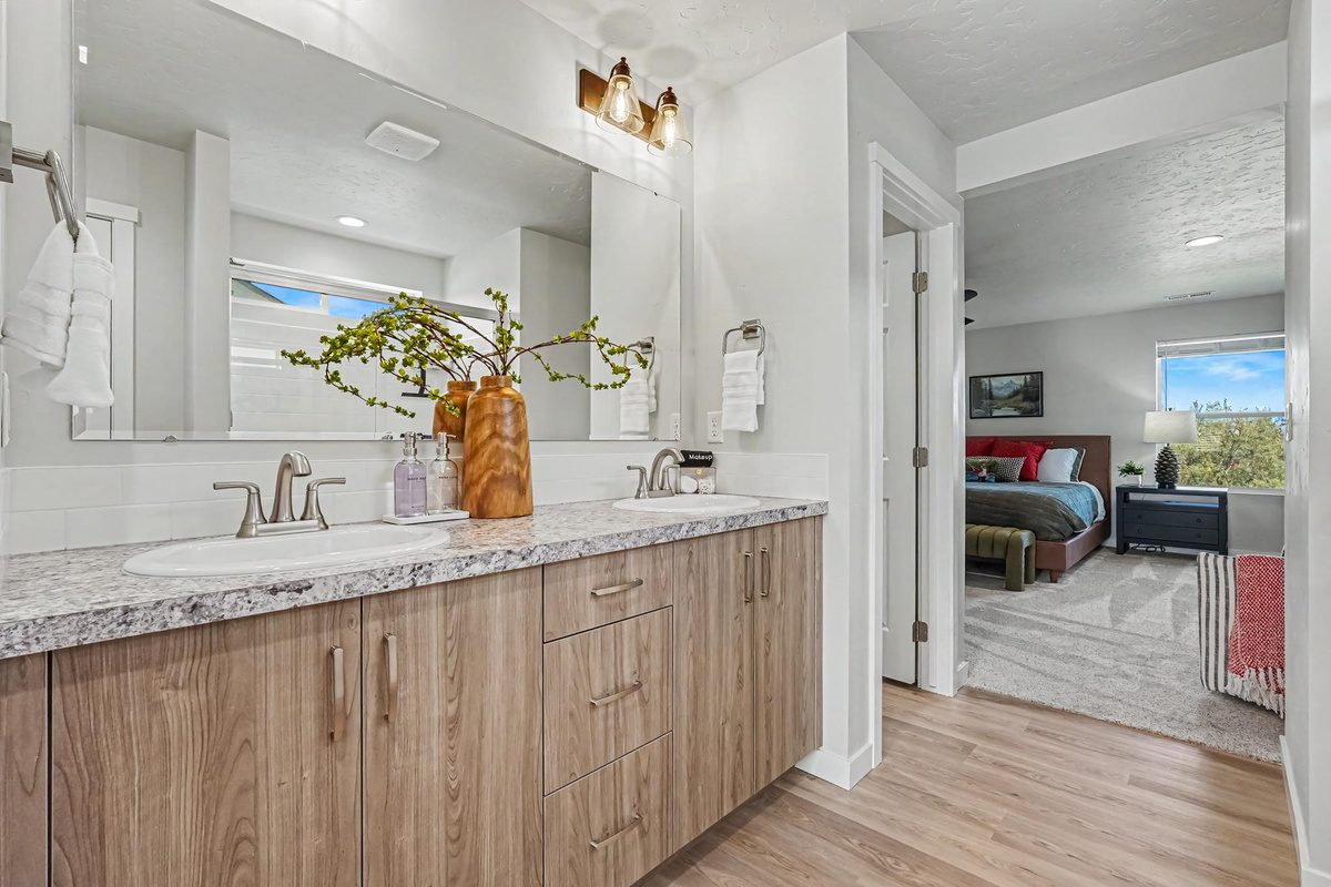 Enjoy the spacious master bathroom, with double sinks and a walk-in shower for comfort, convenience, and a touch of luxury.