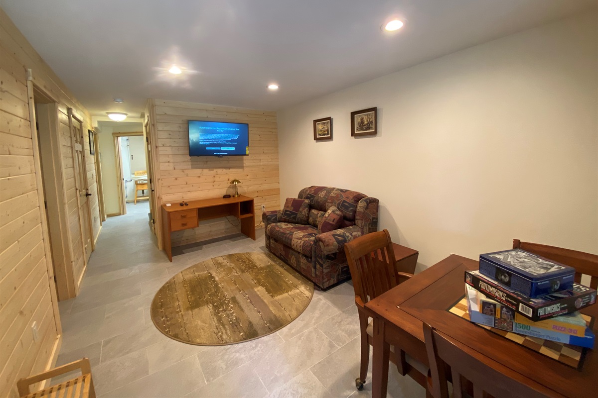 Basement family room has Roku TV, games, gaming table, twin sleeper sofa and features private entry into house.