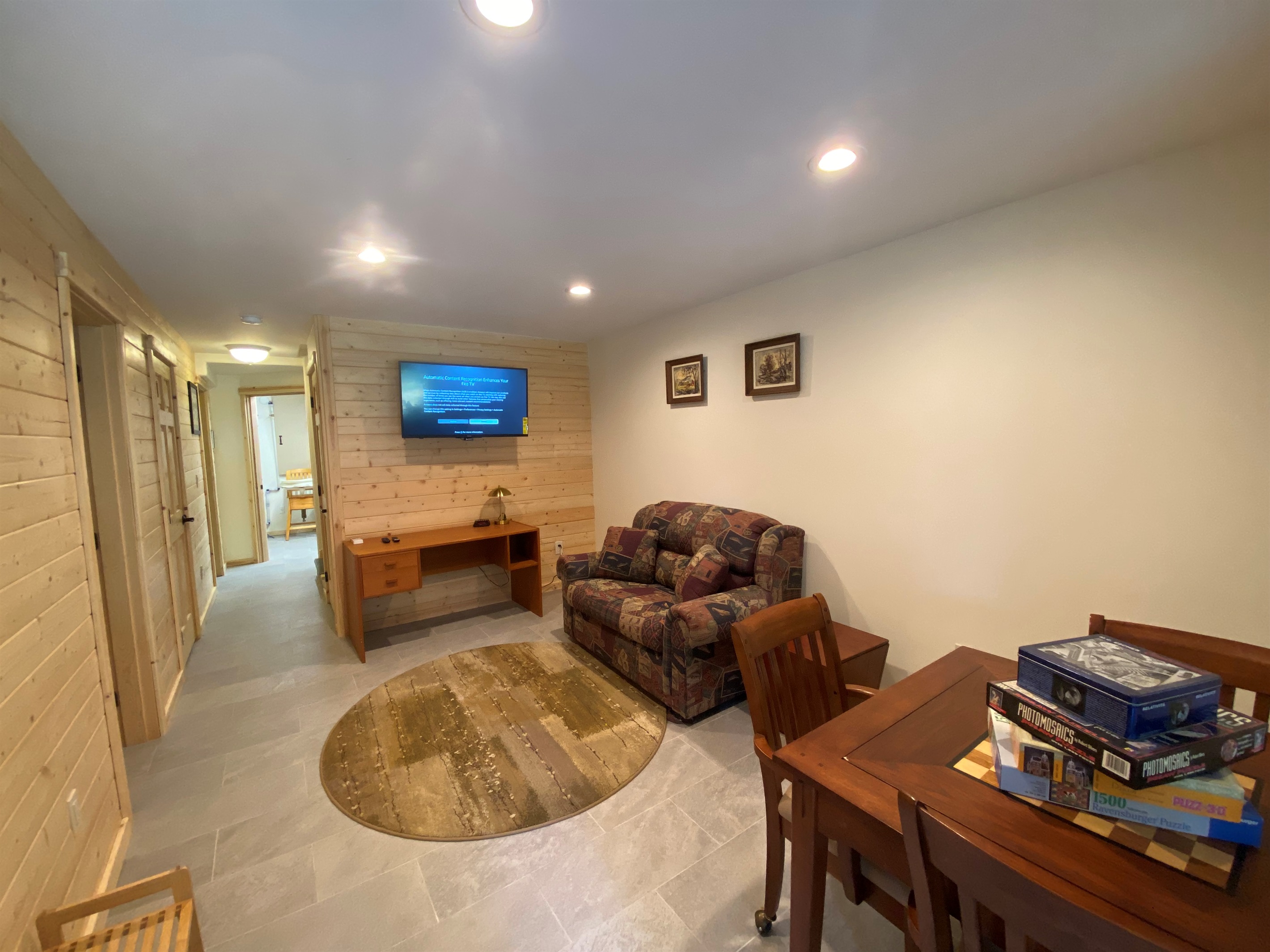 Basement family room has Roku TV, games, gaming table, twin sleeper sofa and features private entry into house.