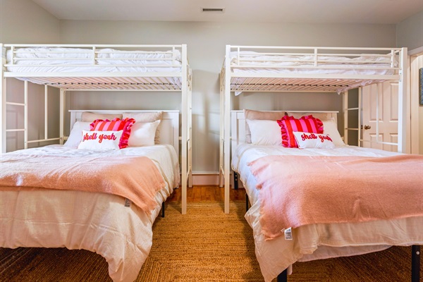 This is the first bedroom down in the basement, featuring two comfy queen beds and two twin beds—plenty of room for everyone!