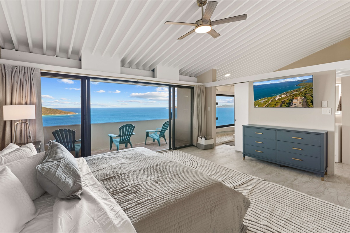 Primary bedroom has a private balcony with seating