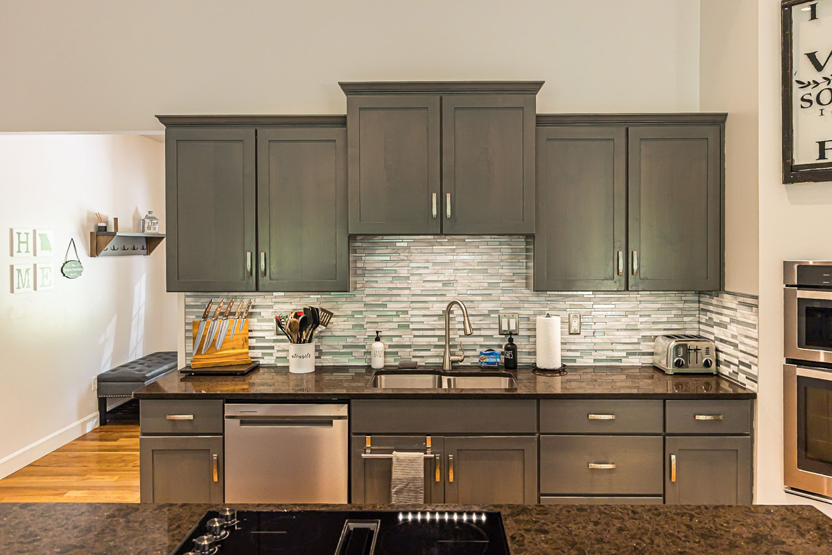 The kitchen is stocked with dishes, cookware, and serving pieces.